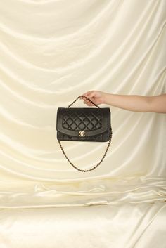 CONDITION: VERY GOOD VINTAGE .?ÿ Crafted from the finest lambskin leather, this medium Diana bag features a sleek and streamlined design with a stunning 24K gold plated chain and hardware. The black color is versatile and perfect for any occasion, while the signature Chanel diamond quilted pattern adds a touch of luxury and elegance. The spacious interior of this bag features multiple compartments, including a zip pocket, allowing you to keep all of your essentials organized and easily accessible. The adjustable chain strap can be as a single or double strap, giving you the flexibility to wear it as a shoulder bag or crossbody. Named after one of the most iconic woman in history, this bag truly carries on the history and elegance of Princess Diana. Crafted in 1991-1994 Strap drop: 20"?ÿ 10 Luxury Black Shoulder Bag With Multiple Compartments, Luxury Black Shoulder Bag With Multiple Pockets, Luxury Vintage Shoulder Bag With Chain Strap, Luxury Vintage Bag With Chain Strap, Luxury Leather Elegant Wallet On Chain, Luxury Versatile Bag With Single Compartment, Elegant Luxury Shoulder Bag With Single Strap, Elegant Luxury Bag With Single Compartment, Luxury Elegant Gold Wallet On Chain