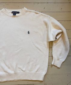 Classic 90s Nautica white cotton pullover sweater. Boxy fit. In excellent vintage condition. Marked a medium, please see measurements. All taken flat. Double where appropriate.  Shoulder 25" Chest 23" Sleeve from pit 22" Length 25" White Cotton Polo Sweater With Ribbed Cuffs, Classic White Polo Sweater With Ribbed Cuffs, Classic White Crew Neck Sweater, White Crew Neck Polo Sweater Casual, White Long Sleeve Cotton Polo Sweater, Classic Cream Cotton Sweater, Vintage White Sweater With Ribbed Cuffs, Casual Cream Cotton Polo Sweater, Vintage Cotton Polo Sweater With Crew Neck