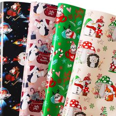 christmas wrapping paper with snowmen, penguins and santa hats on them are lined up next to each other