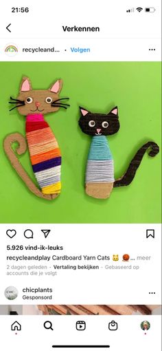 two cats made out of yarn sitting next to each other on top of a green background