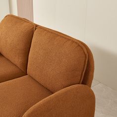 a brown couch sitting on top of a white floor