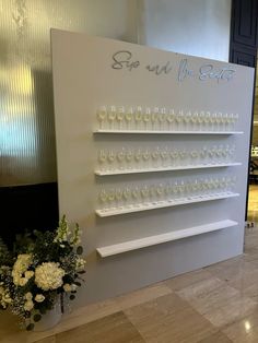 there is a wine glass display on the wall