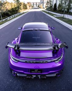 a purple sports car parked on the street