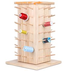 a wooden structure with several different thread spools