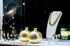 gold jewelry on display in front of a window