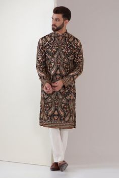 Black georgette kurta with mandarin collar, all over Kashmiri Kalamkari floral, paisley jaal pattern, thread and sequin embroidery. Paired with white straight fit pants.
Components: 2
Pattern: Embroidered
Type Of Work: Kalamkari, Thread and Sequin Work
Neckline: Mandarin Collar
Sleeve Type: Full Sleeves
Fabric: Georgette
Color: Black
Other Details: 
Side slits on kurta
Contrast border details
Kurta Closure: Front concealed placket
Occasion: Destination Wedding,Cocktail and Reception - Aza Fashio Kashmiri Kurta, Kalamkari Kurta, Kashmiri Embroidery, Kurta For Men, Kurta Set For Men, Straight Fit Pants, Indian Fashion Dresses, Sequins Embroidery, Fashion App