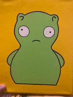 a painting of a green frog with eyes on it's face, sitting in front of a yellow background