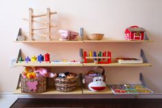 the shelves are filled with toys, books and other things to play with in their room