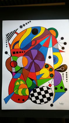 an abstract painting with many colors and shapes on it's white paper, framed in black frame