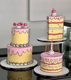 three tiered cakes sitting on top of each other in front of a glass table