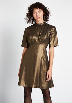 Make a grand entrance at the next soiree in this dark gold A-line dress. Easy to wear with boots or heels, this shimmery, short sleeve piece by Emily and Fin was made for fashionistas—just like you ! Shell: 100% Polyester. Lining: 100% Viscose. Machine wash. Side pockets. Fully lined. Back zipper with button closure. Imported Model is wearing size:S Fabric does not provide stretch. S=36 inches Length XXL=38.5 inches Length | Emily and Fin Shake and Shimmer A-Line Dress in Gold, Size 2XS Gold A Line Dress, Vintage Style Swimwear, Casual Dresses Plus Size, Midi Dress Plus Size, Vintage Swimwear, Midi Dress Casual, Grand Entrance, Dark Gold, Gold Dress