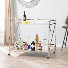 a bar cart filled with liquor bottles and glasses