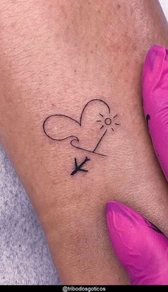 a small tattoo on the arm of a woman with an airplane flying in the sky