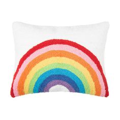 a white pillow with a multicolored rainbow on it