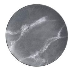 a round metal plate with white marble on the bottom and silver paint streaks in the middle