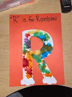 the letter r is for rainbow painted on paper