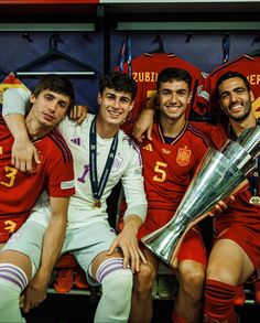 the soccer players are posing with their trophy