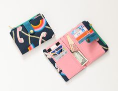 Hi! Thanks for been here!, this is a medium size rainbow wallet, it has 8 card slots, 2 backspaces for bills and 1 zipper coins. the exterior fabric it's a silver blue fabric with rainbows and retro telephones printed on. the inner fabric is pale pink. the metal zipper is green. the strap closure it was made with waxed canvas(waterproof) mosaic bluecolor. the metal button gold color. My wallets are made with high quality material and efficiency in space and compartments. But what distinguishes m Cheap Multicolor Wallet With Zipper Closure, Retro Wallets With Card Slots For Everyday Use, Retro Wallets With Interior Card Slots, Retro Pink Wallet For Everyday Use, Multicolor Trifold Wallet With Card Slots For Daily Use, Trendy Multicolor Wallets With Interior Card Slots, Retro Wallets With Interior Card Slots For Daily Use, Retro Coin Purse With Card Slots For Daily Use, Retro Multicolor Travel Wallet