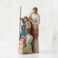 a figurine of a man and woman sitting on a rock next to each other