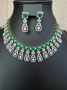 Green Emarald Designer AD Stones/ Premium Quality Necklace Light Weight Necklace and Earring Set/micro gold/South Indian jewelry This item is perfect for parties and festivals! DETAILS: Includes One Choker necklace and two earrings.  Necklace: 13.4 inches. 17 total Extra Chain Lincks will Add Adjustable length. Chain closure. Weighs 1.95 oz (55 g).  Earrings: 1.4 inch(es) long. Earring set weighs 0.20 oz ( 6g) Earring backs push on/off. Material: Imitation Gold Polish Green Emerald, and American Diamond Stone. Finish: Premium GJ gold finish.  NOTE: I try my best to show you photos of my products as they appear in real life, but please note that variations in color occur due to differences in lighting and screen settings.  PRODUCT CARE: - Avoid contact with heat/fire, water, and chemicals s Elegant Gold Plated Green Jewelry Sets, Elegant Green Gold Plated Jewelry Sets, Elegant Green Gold-plated Jewelry Sets, Green Gold Plated Jewelry Set As A Gift, Green Gold Plated Jewelry Set For Gift, Green Gold-plated Jewelry Set For Gift, Gold Emerald Jewelry For Parties, Party Jewelry With Green Emeralds, Party Emerald Jewelry In Green