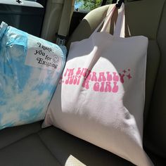 two bags sitting in the back seat of a car, one with a happy birthday message on it