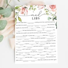 the mad libs game is next to some flowers and greenery on a table