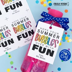 two pink bubbles in a plastic bottle with a blue bow on top and some fun tags attached to them