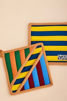 two wooden trays with different colored stripes on them