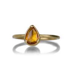 The color of the sacral chakra, orange ignites the throes of passion from deep within. This 18k yellow gold ring from Gabriella Kiss blooms with a pear shaped, faceted orange sapphire. The sparkly 0.76ct stone is set in the artist’s signature scalloped bezel. Stone measures approximately 5/16" x 1/4". Size 6.75. Handcrafted in Hudson Valley, NY, U.S. Orange Saphire Ring Gold, Heirloom Orange Gemstone Ring, Orange Pear-shaped Jewelry, Orange Diamond Ring For Gift, Fine Jewelry, Orange Gemstone-accented Ring Jewelry, Sacral Chakra, Orange Sapphire, 18k Yellow Gold Ring, Stacking Rings