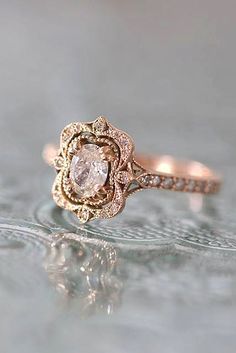 a rose shaped diamond ring on top of a table