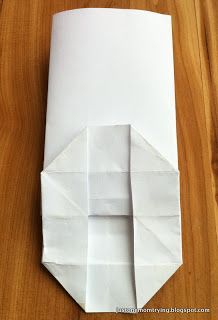 an origami piece is folded in white paper