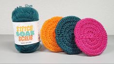 three balls of yarn sitting next to each other on top of a white countertop