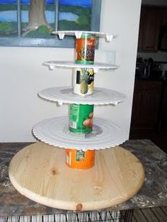 a three tiered shelf with canned food on it