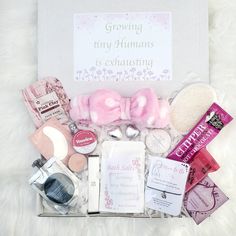 an open gift box containing various items including soaps, makeup and other personal care products