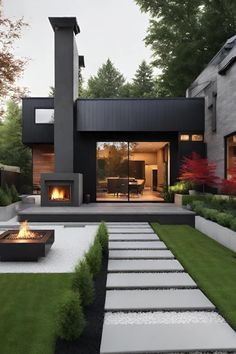 a modern house with a fire pit in the yard