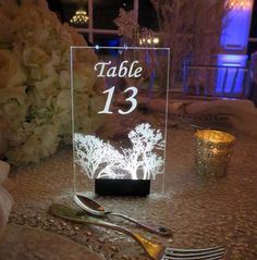 a table with silverware and flowers on it