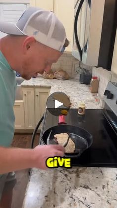 a man cooking food in a pan on top of a kitchen counter next to an oven