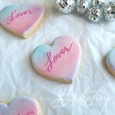 decorated heart shaped cookies sitting on top of a table