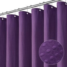 a purple shower curtain hanging on a metal rod