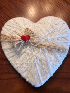 a heart - shaped box with twine wrapped around it