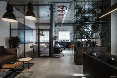 an office with glass walls and lots of plants