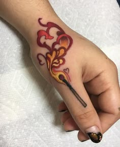 a woman's hand with a tattoo on it and a wand in the middle