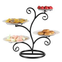 three tiered trays with pastries and fruit on them are shown in this image