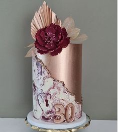 a white and pink cake with flowers on top