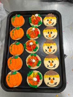 cupcakes decorated to look like pumpkins and jack - o'- lantern faces