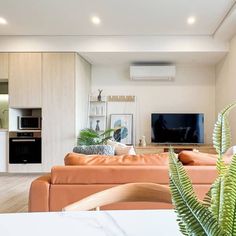 a living room filled with furniture and a flat screen tv on top of a wall