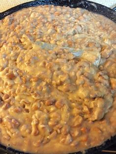 a skillet filled with food sitting on top of a stove