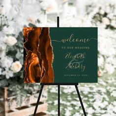 an easel with a sign that says welcome to our wedding and the date is written on it