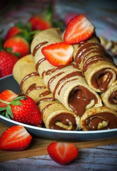 some strawberries and chocolate are on a plate