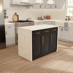 an island in the middle of a kitchen that has white cabinets and wood flooring